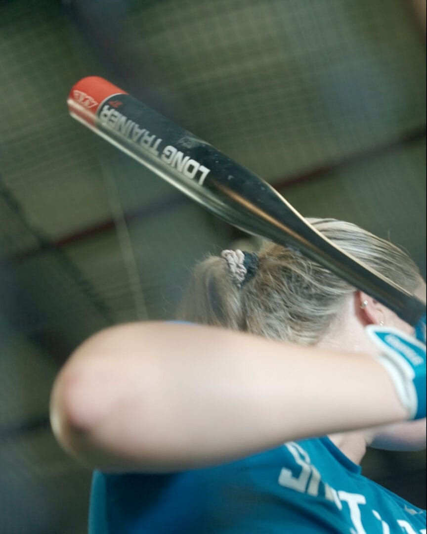 softball athlete using Axe Long Bat Trainer